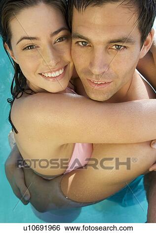 A couple embracing in a pool View Large Photo Image Stock Photograph - A couple embracing in a pool. Fotosearch