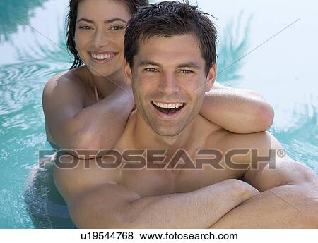 A couple playing in a pool View Large Photo Image Stock Photo - A couple playing in a pool. Fotosearch