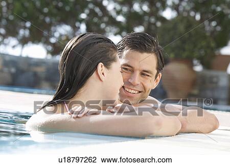 Stock Image - A couple relaxing in a pool. Fotosearch