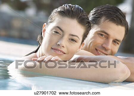 Stock Image - A couple relaxing in a pool. Fotosearch