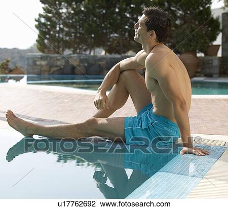 A man relaxing at the edge of a pool View Large Photo Image Stock Image - A man relaxing at the edge of a pool. Fotosearch