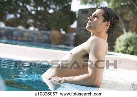 A man relaxing in a pool View Large Photo Image Stock Photo - A man relaxing in a pool. Fotosearch