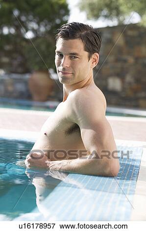 Stock Photo - A man relaxing in a pool. Fotosearch