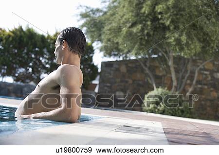 Stock Photo - A man relaxing in a pool. Fotosearch