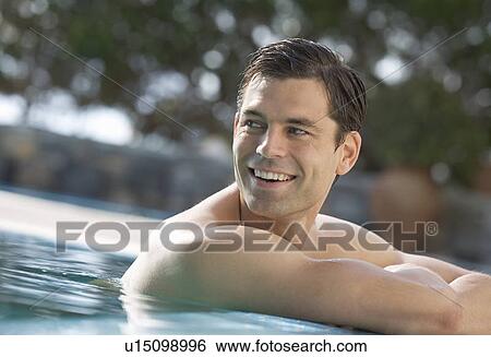 A man relaxing in a pool View Large Photo Image Stock Photograph - A man relaxing in a pool. Fotosearch