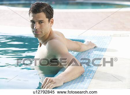 A man relaxing in a pool View Large Photo Image Stock Photography - A man relaxing in a pool. Fotosearch