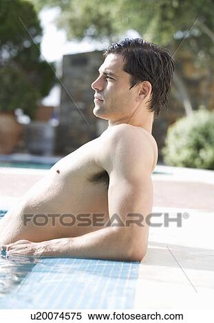 Stock Photography - A man relaxing in a pool. Fotosearch