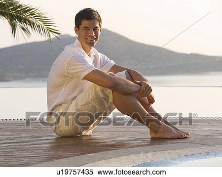 A man sitting by a pool View Large Photo Image Stock Photography - A man sitting by a pool. Fotosearch