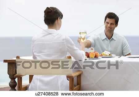 Stock Photo - A couple sharing a romantic meal. Fotosearch