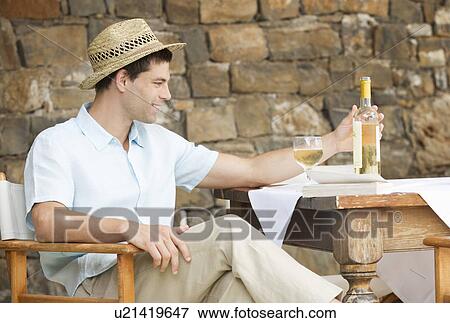 A man drinking a glass of wine View Large Photo Image Stock Photo - A man drinking a glass of wine. Fotosearch