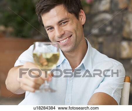 A man enjoying a glass of wine View Large Photo Image Picture - A man enjoying a glass of wine. Fotosearch