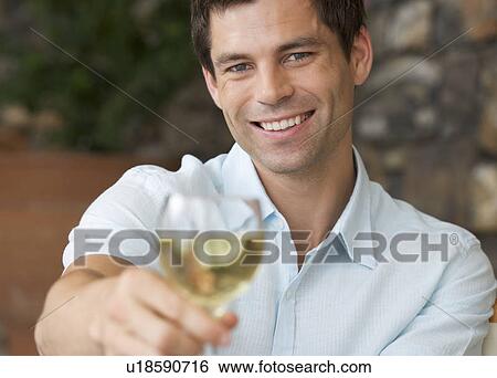 A man enjoying a glass of wine View Large Photo Image Stock Photograph - A man enjoying a glass of wine. Fotosearch