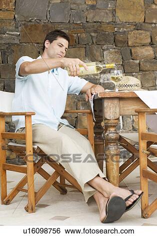 A man pouring a glass of wine View Large Photo Image Stock Photograph - A man pouring a glass of wine. Fotosearch