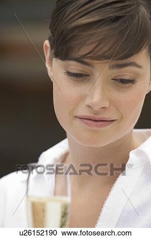 A woman drinking a glass of champagne View Large Photo Image Stock Image - A woman drinking a glass of champagne. Fotosearch