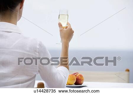 A woman drinking champagne alone View Large Photo Image Stock Photography - A woman drinking champagne alone. Fotosearch