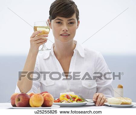 A woman eating alone View Large Photo Image Stock Photograph - A woman eating alone. Fotosearch