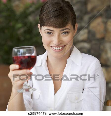 A woman enjoying a glass of wine View Large Photo Image Stock Image - A woman enjoying a glass of wine. Fotosearch