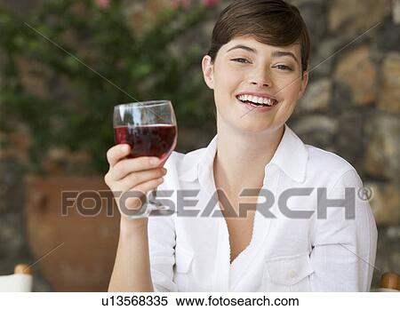 A woman enjoying a glass of wine View Large Photo Image Stock Photography - A woman enjoying a glass of wine. Fotosearch
