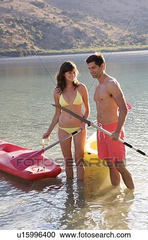 A couple canoeing on a lake View Large Photo Image Stock Image - A couple canoeing on a lake. Fotosearch