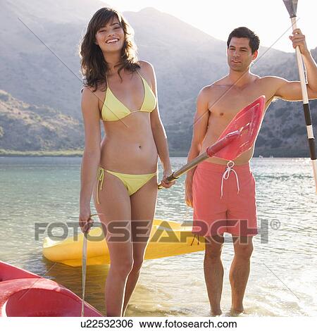 A couple canoeing on a lake View Large Photo Image Stock Photograph - A couple canoeing on a lake. Fotosearch
