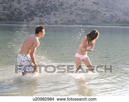 A couple having fun in a lake View Large Photo Image Picture - A couple having fun in a lake. Fotosearch