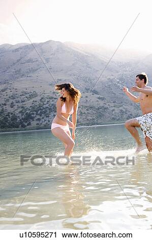 A couple having fun in a lake View Large Photo Image Stock Image - A couple having fun in a lake. Fotosearch
