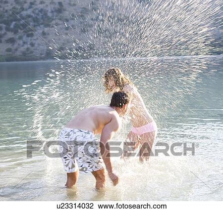 Stock Image - A couple having fun in a lake. Fotosearch