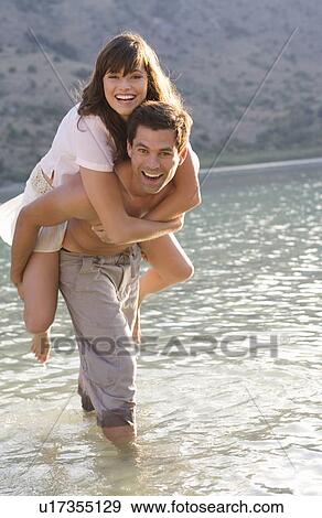 A couple having fun in a lake View Large Photo Image Stock Photo - A couple having fun in a lake. Fotosearch