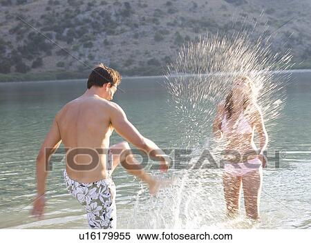A couple having fun in a lake View Large Photo Image Stock Photography - A couple having fun in a lake. Fotosearch