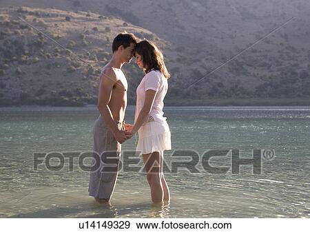 A couple paddling in a lake View Large Photo Image Stock Photo - A couple paddling in a lake. Fotosearch