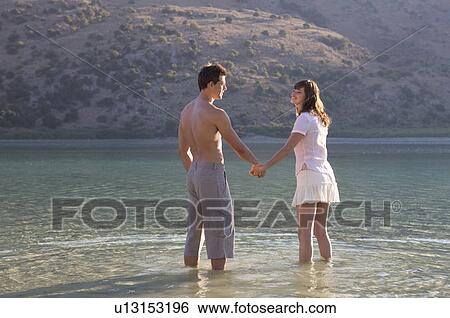 A couple paddling in a lake View Large Photo Image Stock Photograph - A couple paddling in a lake. Fotosearch
