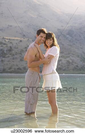 A couple paddling in a lake View Large Photo Image Stock Photograph - A couple paddling in a lake. Fotosearch