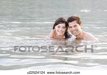 A couple swimming in a lake View Large Photo Image Picture - A couple swimming in a lake. Fotosearch