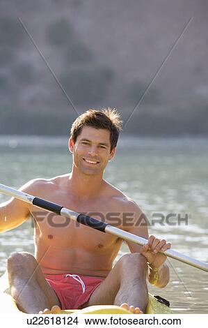A man canoeing on a lake View Large Photo Image Picture - A man canoeing on a lake. Fotosearch
