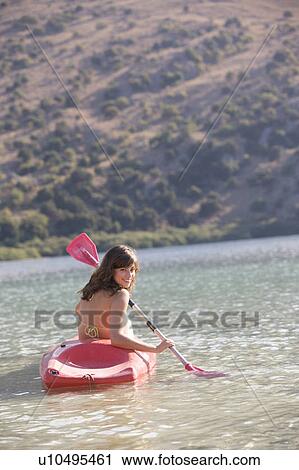A woman in a kayak View Large Photo Image Stock Image - A woman in a kayak. Fotosearch