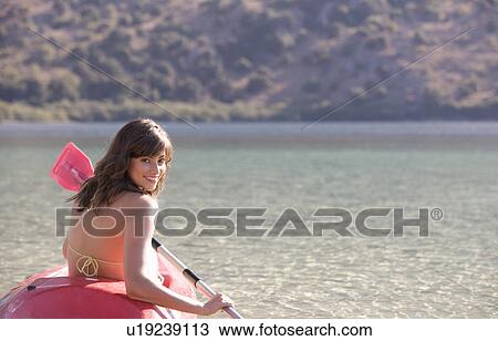 A woman in a kayak View Large Photo Image Stock Image - A woman in a kayak. Fotosearch