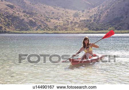 Stock Photo - A woman in a kayak. Fotosearch