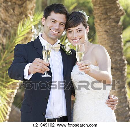 A bride and groom drinking champagne View Large Photo Image Stock Image - A bride and groom drinking champagne. Fotosearch