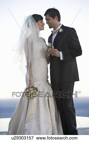 A bride and groom drinking champagne View Large Photo Image Stock Photo - A bride and groom drinking champagne. Fotosearch