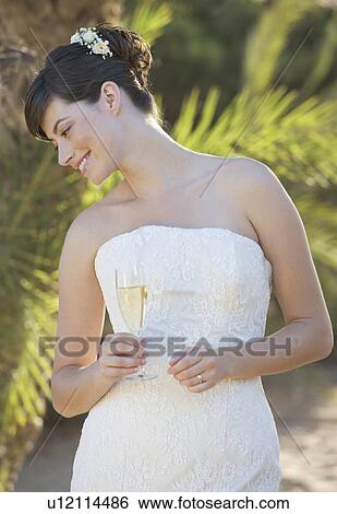 A bride drinking champagne View Large Photo Image Stock Photograph - A bride drinking champagne. Fotosearch