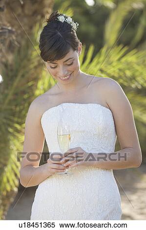 Stock Photography - A bride drinking champagne. Fotosearch