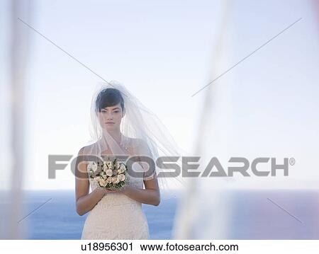 A bride holding her bouquet View Large Photo Image Stock Image - A bride holding her bouquet. Fotosearch