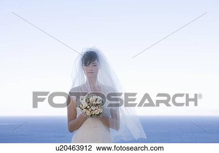 A bride holding her bouquet View Large Photo Image Stock Image - A bride holding her bouquet. Fotosearch