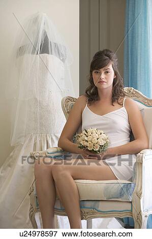 Stock Photo - A bride sitting in a chair. Fotosearch