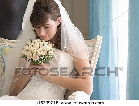 A bride sitting on a chair View Large Photo Image Stock Photo - A bride sitting on a chair. Fotosearch