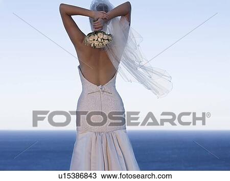 A bride throwing her bouquet away View Large Photo Image Stock Image - A bride throwing her bouquet away. Fotosearch