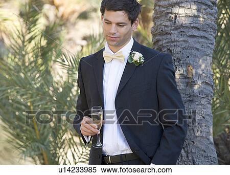 A groom drinking champagne View Large Photo Image Stock Photography - A groom drinking champagne. Fotosearch