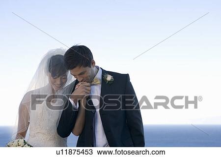 A groom kissing his bride's hand View Large Photo Image Stock Image - A groom kissing his bride's hand. Fotosearch