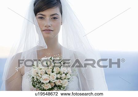 Portrait of a bride holding her bouquet View Large Photo Image Stock Image - Portrait of a bride holding her bouquet. Fotosearch