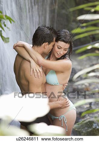 A couple kissing in a waterfall View Large Photo Image Stock Image - A couple kissing in a waterfall. Fotosearch